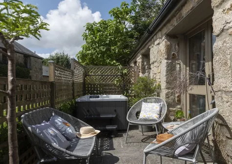 The patio, outdoor sitting area & hot tub at The Old Dairy, Carnhell Green