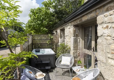 The patio, outdoor sitting area & hot tub at The Old Dairy, Carnhell Green