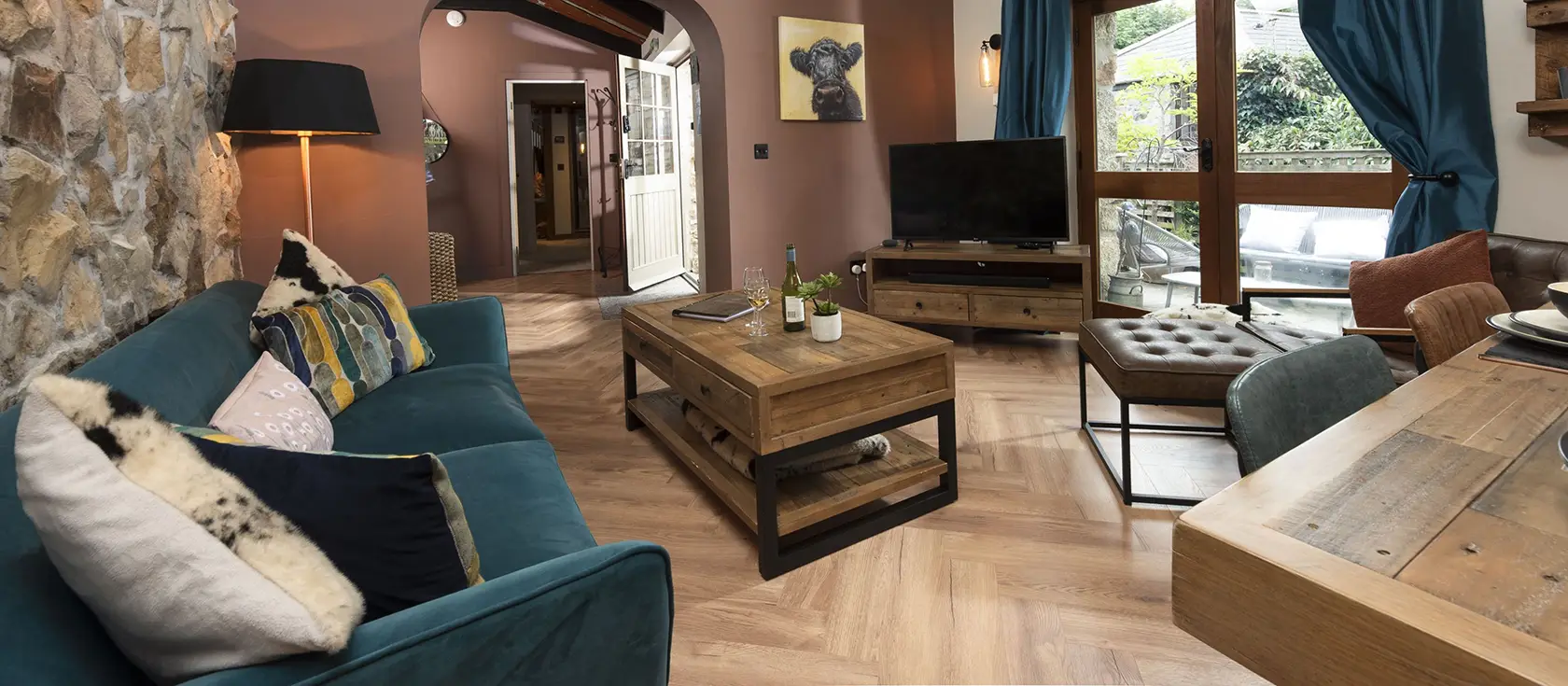 The Old Dairy, Carnhell Green is a luxurious barn conversion featuring a bubbling hot tub, shared heated pool, and magical children's den with mezzanine sleeping. Perfect for families seeking rustic charm with modern comforts in rural Cornwall.