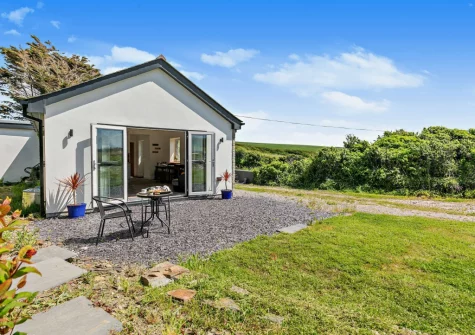 The patio, outdoor sitting area & garden at The Old Duck House, Porthcothan