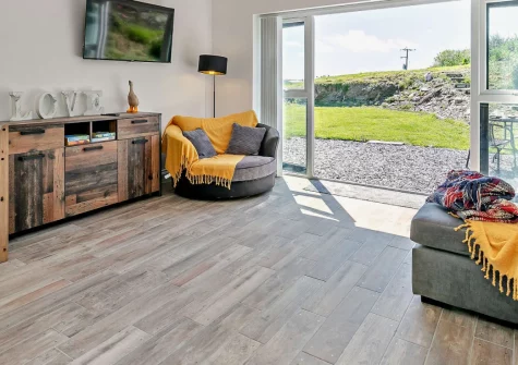 The Old Duck House, Porthcothan is a beautifully converted barn for two, with sweeping bay and countryside views, underfloor heating throughout, and direct access to stunning coastal walks, making it perfect for romantic getaways year-round.