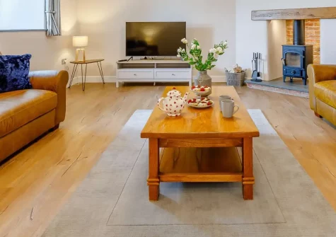 The Old Granary, Rookabear, Combrew is a stylish three-bedroom barn conversion with panoramic countryside views, a dedicated children's play area, and elegant interiors. It's a perfect base for memorable family getaways near North Devon's coast.
