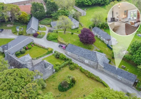 The Old Mill Cottage is a converted stone barn on the grounds of a 16th-century manor house