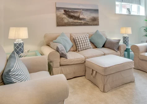The Old Sail Loft, Beer is a stylish cottage in a pretty Jurassic Coast fishing village, featuring open-plan living with underfloor heating, nautical interiors, a large dining table for gatherings, and the South West Coast Path on the doorstep.