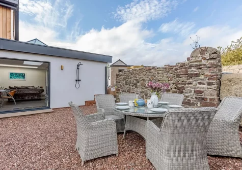The alfresco dining area & enclosed garden at The Old School House, Westleigh
