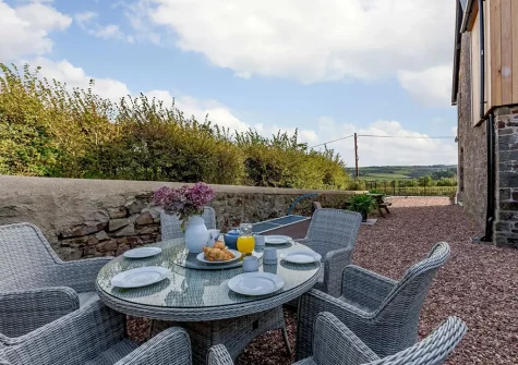The alfresco dining area & enclosed garden at The Old School House, Westleigh