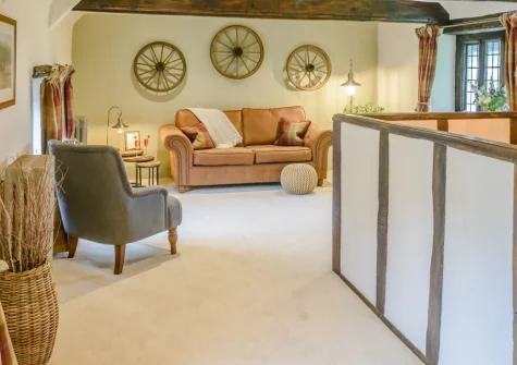 The Old Stables at Stafford Barton, Dolton is a beautifully presented one-bedroom cottage within a historic manor's 750-acre estate, featuring hand-crafted oak interiors, peaceful moorland walks with Exmoor ponies, and easy access to both coasts.