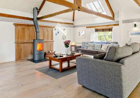 The Old Sunday School, Rumford is a characterful Grade II-listed conversion in peaceful North Cornwall, featuring original arched windows, cosy wood burner, and stylish interiors, with coastal beaches and Padstow's renowned restaurants close by.