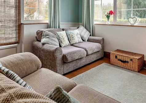 The Orangerie, Gilbert's Coombe is a cottage retreat featuring light-filled dual-aspect rooms, a cosy wood burner, and multiple outdoor spaces. This Cornish hideaway offers easy access to coastal paths, sandy beaches, and historic mining trails.