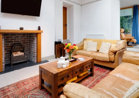 The Orangery, Lynton Cottage is an elegant first-floor apartment in a Grade II-listed Victorian residence, offering panoramic sea views from its private balcony, light-filled living spaces beneath a stunning skylight, and clifftop walks on Exmoor.