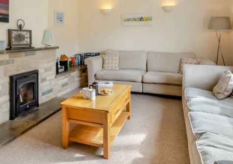 The Pidgeon Nest, Axmouth is a welcoming three-bedroom family home in the heart of historic Axmouth, featuring a generous enclosed garden, cosy wood burner, and superb access to Seaton Beach, riverside walks, and the dramatic South West Coast Path.