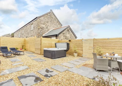 The enclosed garden, outdoor sitting, hot tub, barbecue & alfresco dining area at The Piggery at Glen View, Burncoose