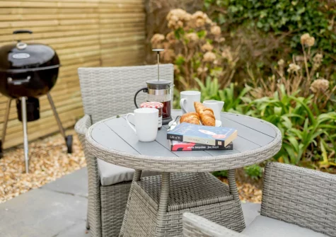 The enclosed garden, barbecue & alfresco dining area at The Piggery at Glen View, Burncoose