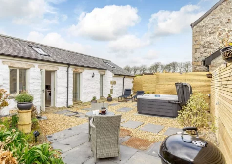 The enclosed garden, outdoor sitting, hot tub, barbecue & alfresco dining area at The Piggery at Glen View, Burncoose