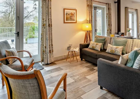 The Piggery, High Bickington is a charming barn conversion on a working farm with private hot tub and wild gardens. Perfect for couples and families seeking peaceful rural escape with cosy wood burner warmth and modern comfort in North Devon.