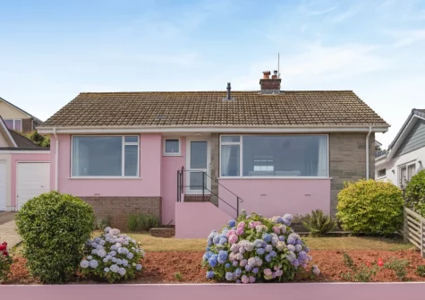 Painted in pale pastel pink, The Pink Beach Bungalow is a bright & light bungalow with breathtaking views of the coastline