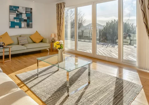 The Reeds, Croyde, is a spacious 3-bedroom bungalow with stunning panoramic sea views, just 0.25 miles from world-class Croyde Beach. Enjoy contemporary coastal living, outdoor dining on the south-facing deck, and convenient surfboard storage.