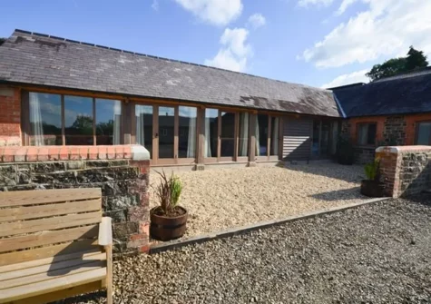 The Root House is a charming converted barn with original features, set in a peaceful farm courtyard