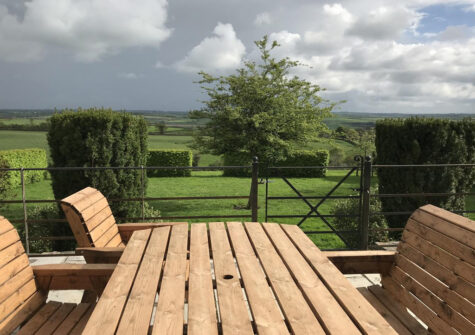 The patio & far reaching countryside view at The Roundhouse, West Anstey