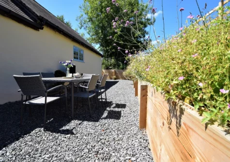The gravelled courtyard, barbecue & alfresco dining area at The Shippen at Upper Yeoland, Swimbridge