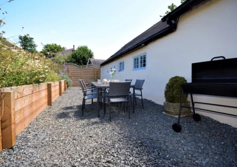 The gravelled courtyard, barbecue & alfresco dining area at The Shippen at Upper Yeoland, Swimbridge