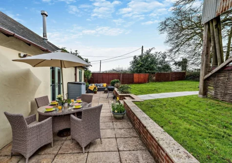 The rear patio, alfresco dining area & garden at The Shippon, Hembury Gate Farm, Sheepwash
