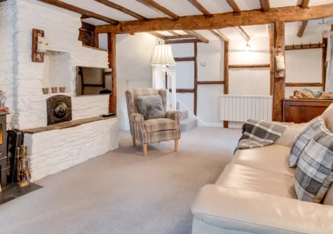 The Smithy, Croyde is a characterful Grade II-listed cottage in the heart of this renowned surfing village, featuring a cosy wood burner, romantic beamed interiors, a unique glass-covered well, and Croyde's golden beach just moments away.