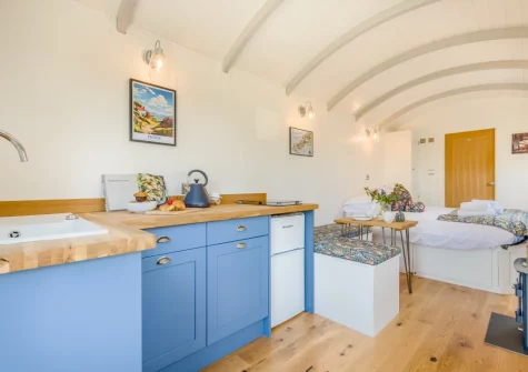 The shepherd's hut kitchen & dining area at The Smithy, Feock
