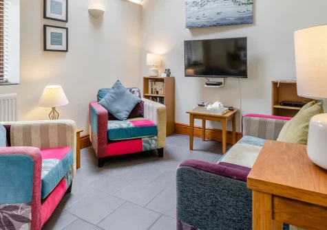 The Stable, Dunmere is a beautifully converted former stable set in peaceful Cornish countryside, featuring skylights flooding the reverse-level layout with natural light, a private enclosed garden, and direct access to the Camel Trail for cyclists.