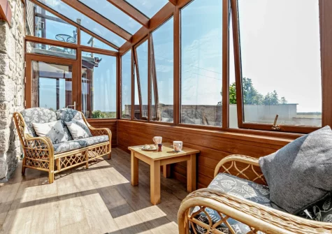 Bedroom #1 sun room sitting area at The Stables at Brea Farm, Trevegean