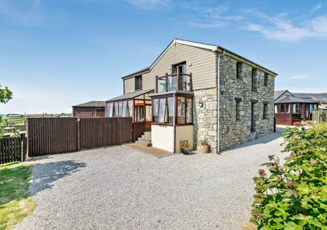 The Stables at Brea Farm is a stylish reverse-level barn has open-plan living space located on the first floor, making the most of the stunning far-reaching views