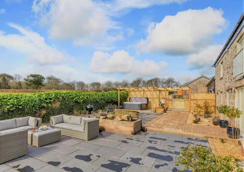 The patio, outdoor sitting area & hot tub at The Stables at Glen View, Burncoose