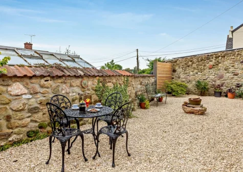 The gravelled courtyard, barbecue & alfresco dining area at The Stone Barn, Dulford