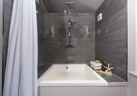 The Japanese-style plunge bath with overhead drench shower at The Store Room, Mousehole