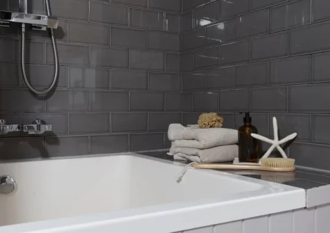 The Japanese-style plunge bath with overhead drench shower at The Store Room, Mousehole