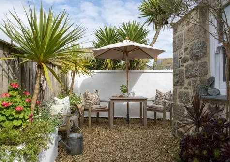The wrap-around courtyard garden & alfresco dining area at The Store Room, Mousehole