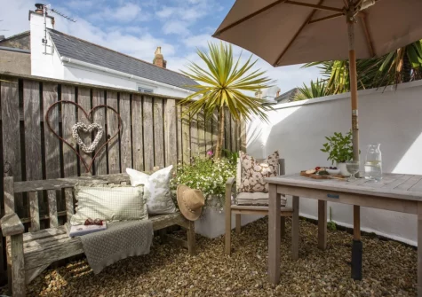 The wrap-around courtyard garden & alfresco dining area at The Store Room, Mousehole