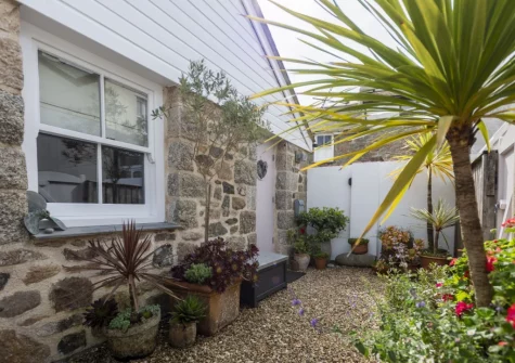 The wrap-around courtyard garden at The Store Room, Mousehole