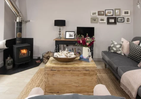 The Store Room, Mousehole is a luxurious one-bedroom cottage just steps away from this picture-perfect harbour village, featuring a sumptuous king-size bed with plunge bath, vaulted living spaces, and a sun-drenched courtyard garden.