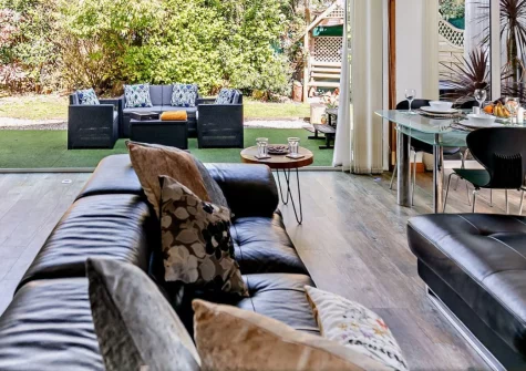 The Studio, Cubert is a beautiful three-bedroom cottage in a peaceful village setting, featuring a private wood-fired hot tub, stylish open-plan living with bi-folding doors to the garden, and National Trust beaches within easy walking distance.