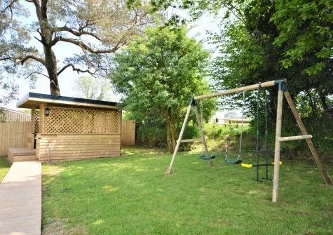 The private covered hot tub & garden with swing set at The Swallows Barn, Bray Shop