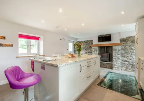 The kitchen, with the the old well that the owners have lovingly kept, at The Swallows Nest, Launceston