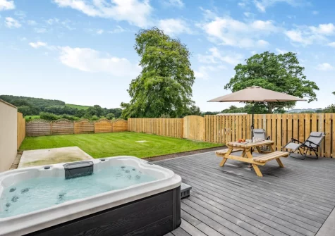 The decked patio, alfresco dining area, hot tub & enclosed garden at The Swallows Nest, Launceston