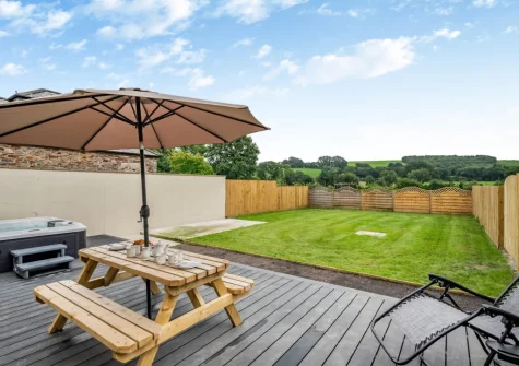 The decked patio, alfresco dining area, hot tub & enclosed garden at The Swallows Nest, Launceston