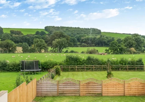 The enclosed garden and surrounding countryside at The Swallows Nest, Launceston
