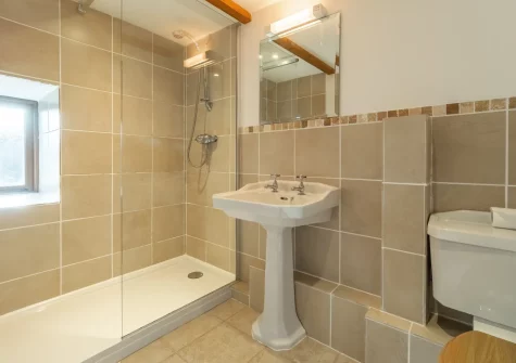 Bedroom #1 en-suite shower room at The Threshing Barn at Cusgarne Cottages, Cusgarne