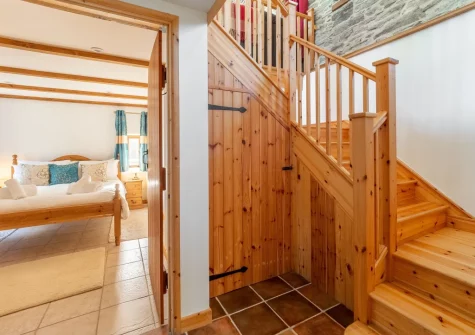 The stairs up to the first floor at The Threshing Barn at Cusgarne Cottages, Cusgarne