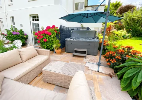 The patio, outdoor sitting area & hot tub at The Town House at Muntham, Torquay