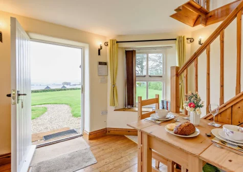 The dining area & stairs up to the first floor at The Watchtower, Bickington