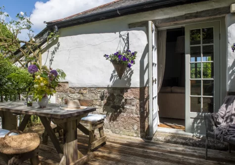 The decked terrace, barbecue & alfresco dining area at The Watermill, Withiel